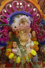 Ganapati festival celebration at home with a beautifully decorated Ganesh idol, flowers, lights, and traditional offerings, symbolizing devotion, prosperity, and cultural heritage in a festive atmosph