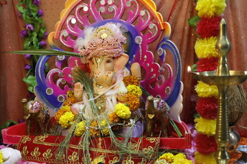 Ganapati festival celebration at home with a beautifully decorated Ganesh idol, flowers, lights, and traditional offerings, symbolizing devotion, prosperity, and cultural heritage in a festive atmosph