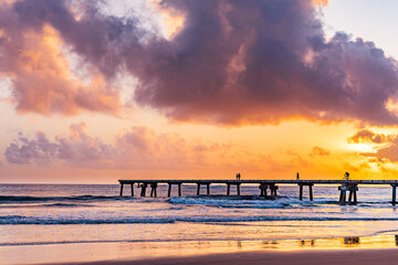 Fototapeta premium Butwani bridge and Malindi Pier area is a popular waterfront location known for stunning sunrises over the Indian Ocean. The pier is a concrete jetty that stretches about 400 meters into the ocean and