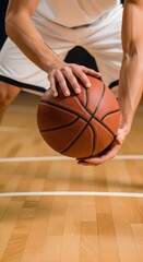 Naklejka premium Dynamic basketball scene with player dribbling orange ball on indoor court, detailed action shot for stock sports photography