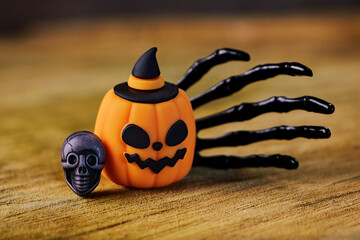 halloween card with jack o pumpkin, skull and black hand close-up, congratulations on All Saints Day