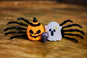 vibe halloween card with pumpkin jack o, skull, two black hands and ghost close-up, congratulations on All Saints Day