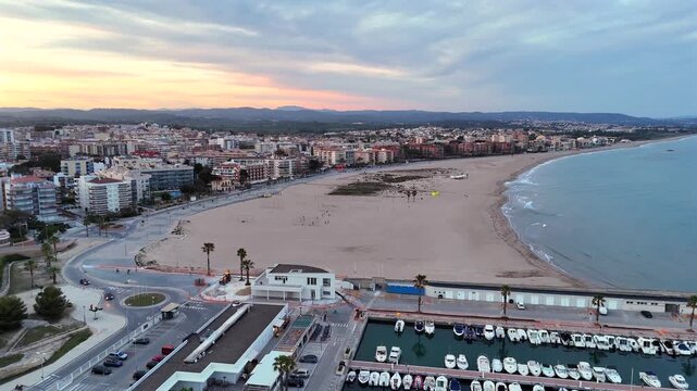 Torredembarra, Spain aerial drone video - Drone shot of the town of Torredembarra or &ldquo;La Torre&rdquo; along the coast of Spain with a long sandy beach