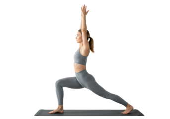 Young caucasian woman in grey athletic wear on black mat, gracefully performing high lunge yoga pose with Anjali Mudra in high-key white studio, exuding calm focus and inner strength. Concept of