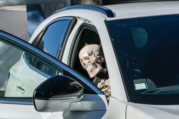 A funny scene of a skeleton passenger waiting inside a car A Strange Road Trip