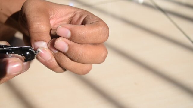 Cutting long little finger nails