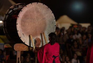 musician playing traditional Japanese taiko drum, Kumi-daiko performance