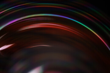 	
Bright multicoloured liquid surface on black background, interference pattern, one colourful curved line