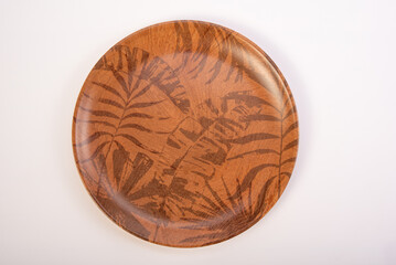 Beautiful ceramic plate placed on a white background, selective focus. Top view.