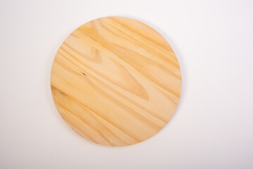 Beautiful wooden kitchen cutting board placed on a white background, selective focus. Top view.