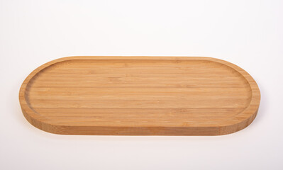 Beautiful wooden kitchen cutting board placed on a white background, selective focus.
