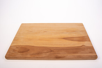Beautiful wooden kitchen cutting board placed on a white background, selective focus.