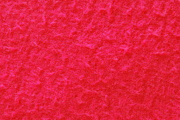 Red soft fluffy pilling fabric texture as background © Irina