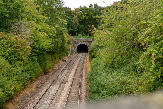 Railway track leading to the tunnel. A tunnel on a railway passing through a rainforest. Traveling by train. High quality photo