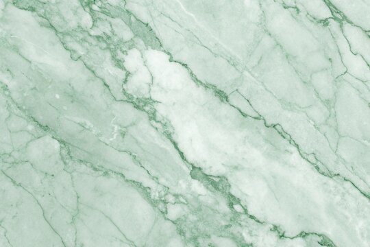 Closeup of a light green marble texture with intricate veining, creating a natural and elegant pattern suitable for backgrounds and design projects