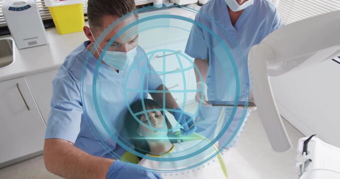 Male dentist leaning over patient and initiating dental cyber security scan with expanding rings