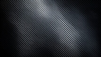 Black carbon fiber texture showing smooth and reflective pattern with diagonal lines and depth, ideal for design inspiration