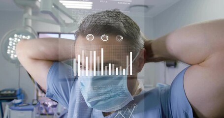 Male surgeon securing mask in operating suite, activating holographic medical charts and graphs - Powered by Adobe