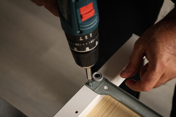 Light wood. Collecting new furniture. Using tools