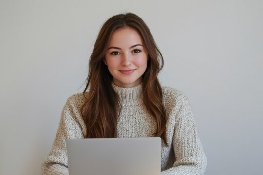 Confident young woman working remotely using laptop, enjoying work life balance in cozy home environment - Powered by Adobe
