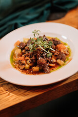 Elegant gourmet beef stew served at a romantic candlelit dinner celebration