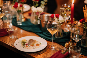 Gourmet fish fillet served with creamy sauce and microgreens on elegant dinner table