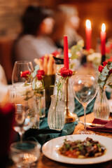 Pouring rose wine into a glass during romantic candlelit dinner with elegant table decor