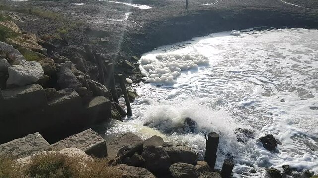 Torrents of water rush through floodgates in the Carboneros marshes, Chiclana de la Frontera, C&aacute;diz, Spain. A dynamic scene of nature, flow, and hydraulic infrastructure.