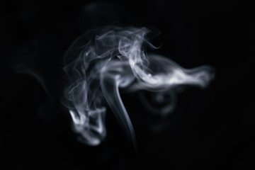 A graceful swirl of smooth white smoke against a dark background, forming a beautiful flowing shape