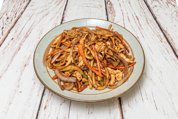 Romantic Asian dinner: thin noodles sautéed with scallops and asparagus, presented on a porcelain...
