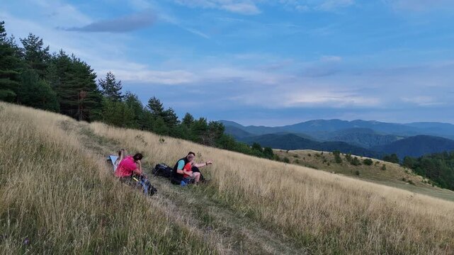 Family on the mountain. Parents and children hiking trip, enjoying trees and fresh air. Authentic family lifestyle.