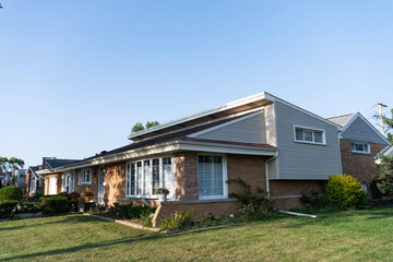 Obraz premium Residential property house. Residence architecture. Suburban neighborhood. Suburban house architecture. Private house. Neighborhood architecture. Property in neighborhood. Quiet neighborhood