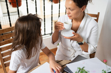 Mother and Daughter Bonding Over Coffee and Drawing Outdoors