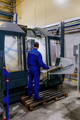 Fototapeta premium Operator works with modern CNC milling and cutting machinery