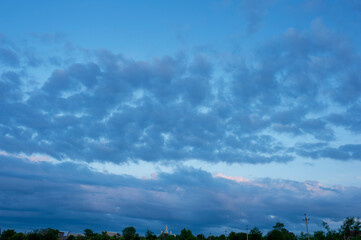 A picturesque view of a colorful sky landscape during sunset. Smooth swirls of colors shimmer in the evening rays of light.