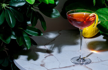 Strong alcoholic cocktail drink with gin, aperitif, bitters, liqueur and lemon twist with bar tools