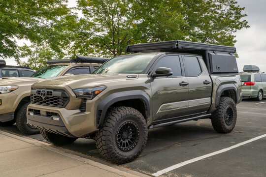 Loveland, CO, USA - August 22, 2025: 4th generation Toyota Tacoma truck in TRD Pro trim,  i-Force Max hybrid powertrain, set up for overlanding with Super Pacific camper.