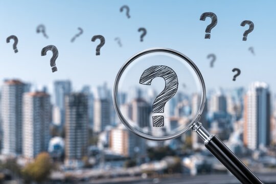 Magnifying glass focusing on a question mark over a cityscape - Powered by Adobe