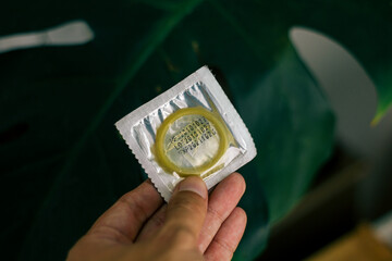 condom in a package in the interior of a living room in a residential building. concept: unwanted...
