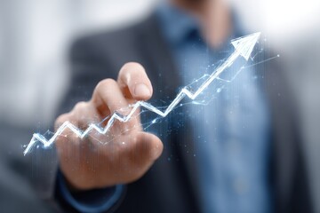 Business person's hand pushing upward trending graph