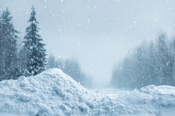 Snowy landscape with a pile of snow in the foreground, trees in the background, and falling snow