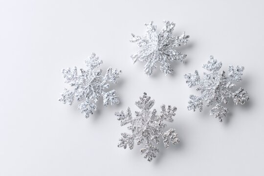 Four silver snowflakes on a white background - Powered by Adobe