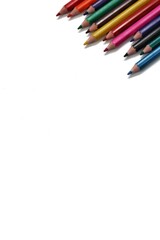 A vibrant cluster of colorful pencils neatly arranged in the top left corner of the frame, offering significant negative space for text or other design elements.