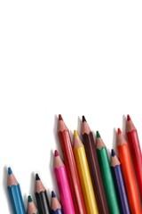 A vertical shot emphasizing the colorful bases of a group of pencils, positioned at the bottom of the frame to create significant negative space above for custom text or designs.
