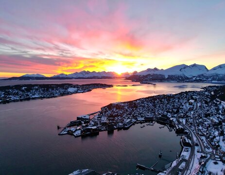 Aerial view of a wintry fjord town at sunset - Powered by Adobe