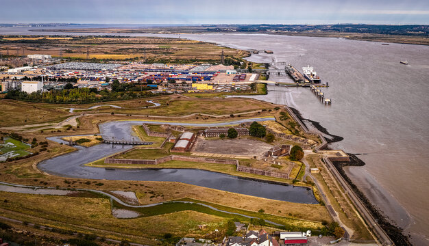 Drone shot of historic Tilbury Fort in Essex, UK, showcasing its star-shaped defensive design by the Thames. Great for themes like heritage, tourism, architecture, and military history visuals