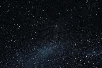 Fototapeta premium Night sky filled with countless stars, a faint milky way streaking across