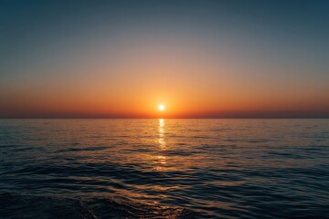 Wide shot of a serene sunset over a calm sea