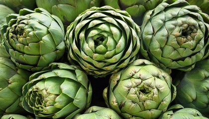 Obraz premium vibrant green artichokes are piled together highlighting their intricate shapes and textures