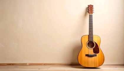 Naklejka premium Acoustic guitar on beige wall